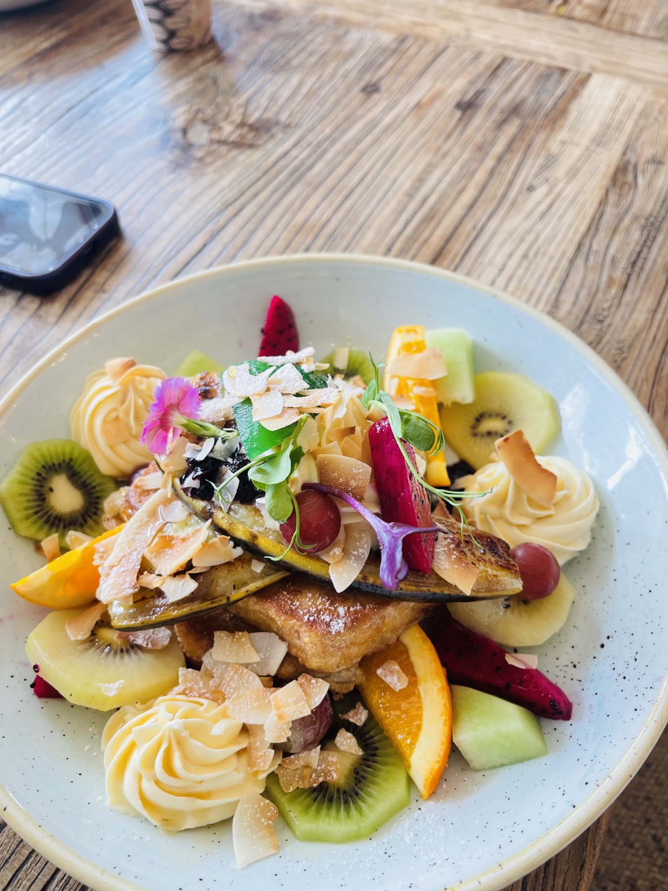 Coconut French toast with fresh fruit at Little Q